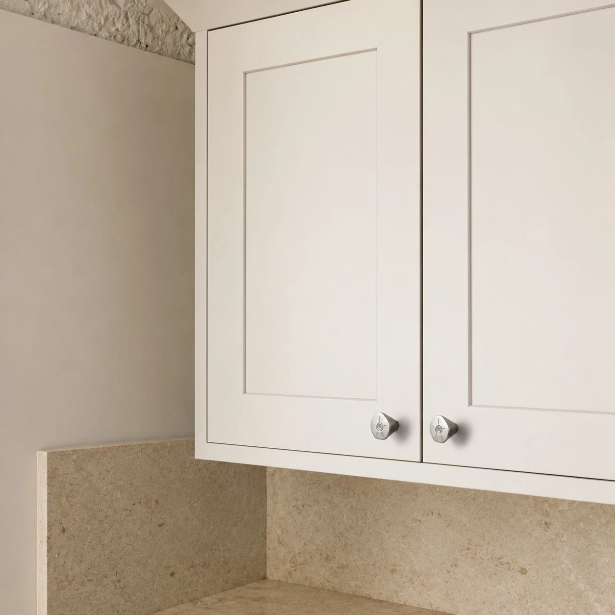 Titanium silver knobs on white cabinet doors