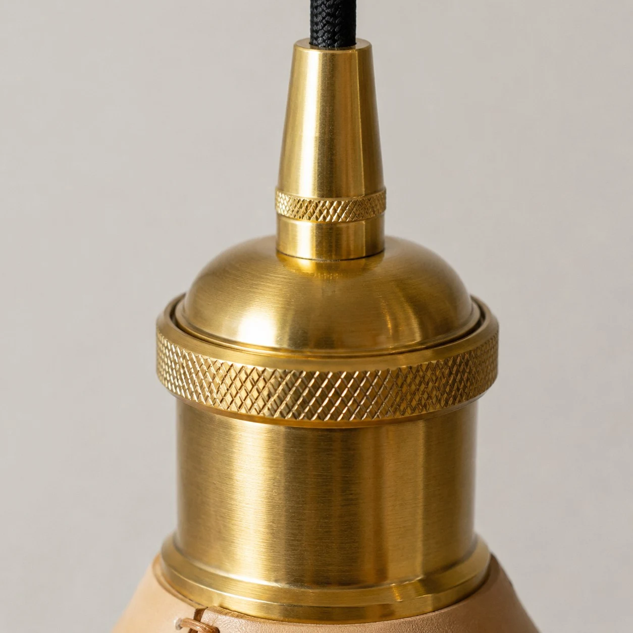 Brass tone cap and hanging cord detail