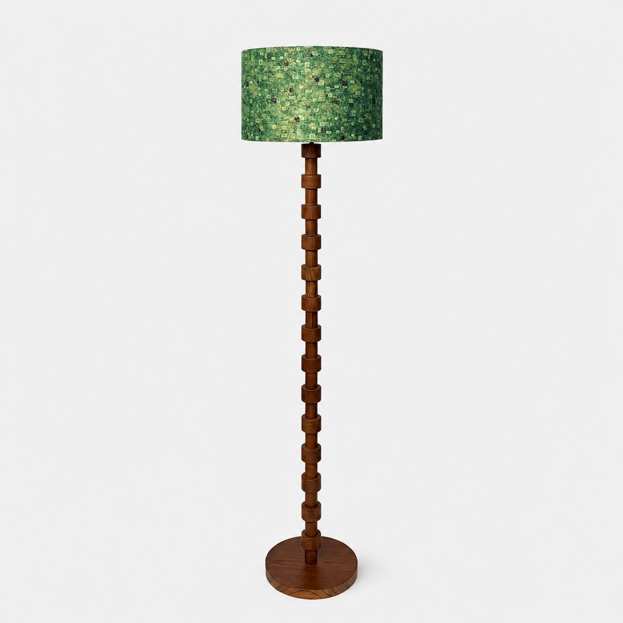 Full view of sculptural wood floor lamp with patterned fabric drum shade