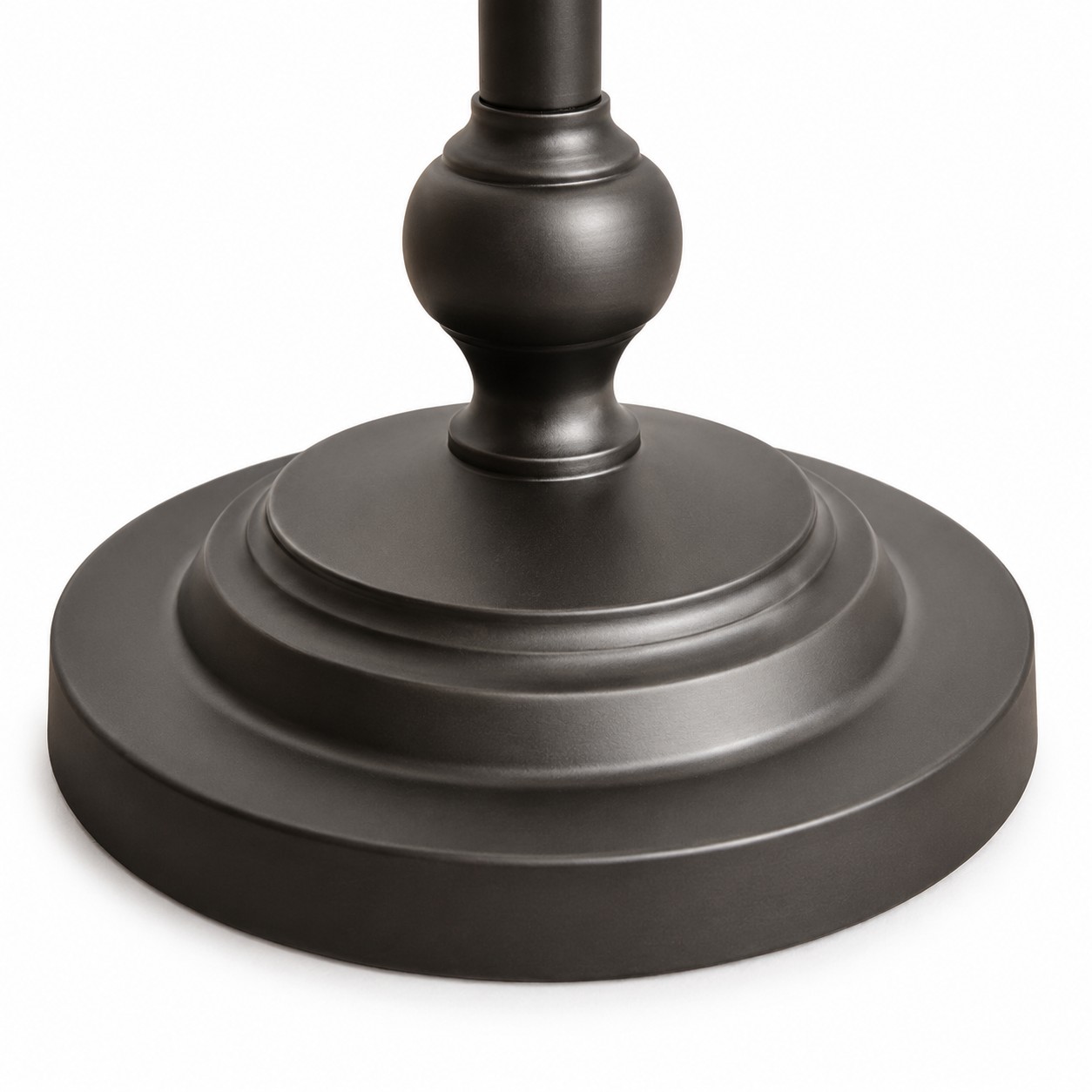 Close-up of the layered round base on the black metal floor lamp